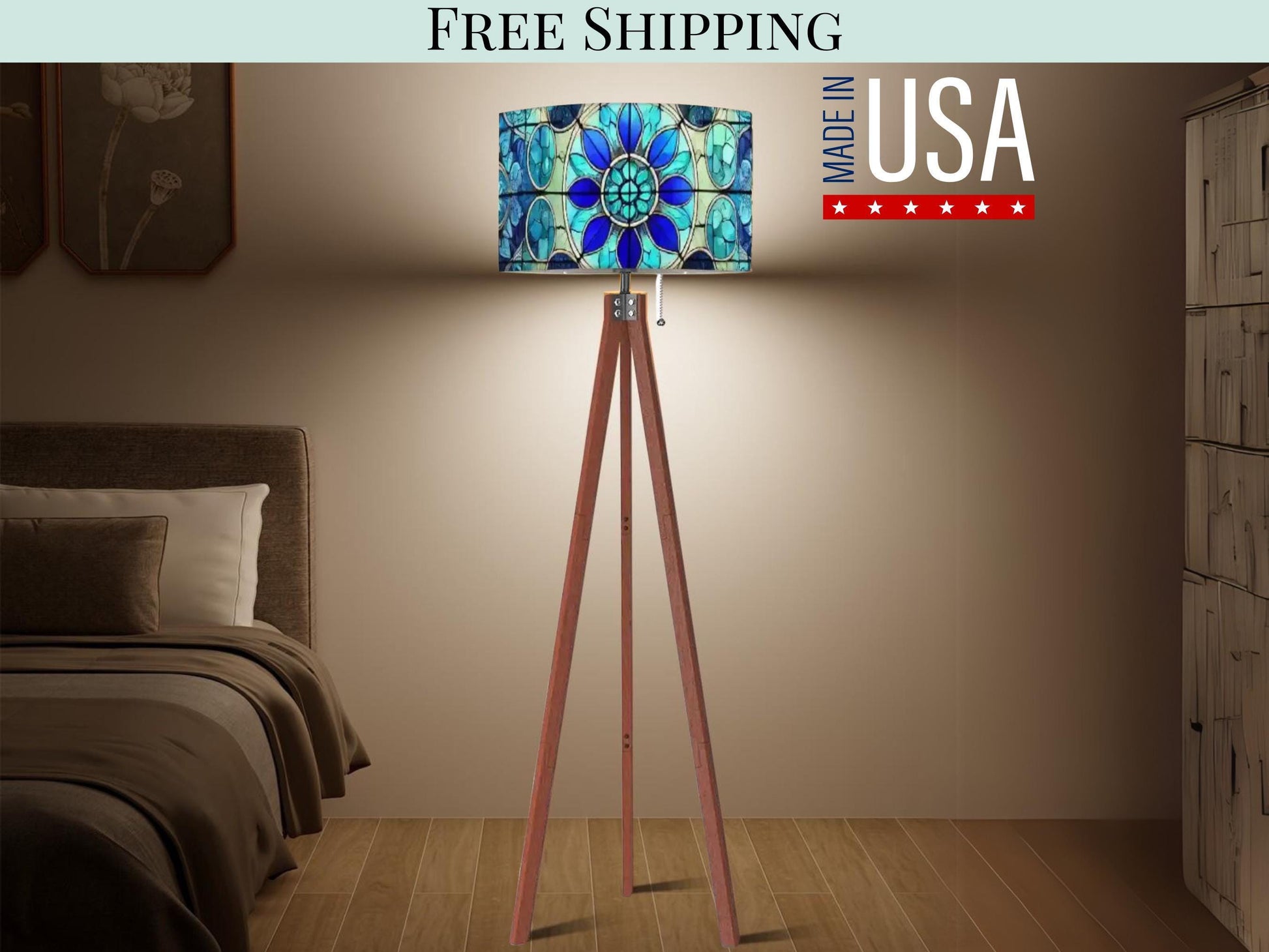 a modern bedroom with a wooden tripod floor lamp featuring a colorful stained glass design. The lamp is placed on a wooden stand, and the text "FREE SHIPPING MADE IN USA" is displayed above it.
