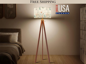 a bedroom with a bed, a lamp on a tripod stand, and a sign that reads "Made in USA".