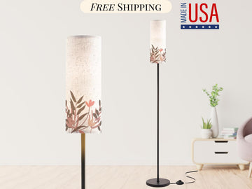 a modern floor lamp with a floral design on the lampshade, placed in a minimalist living room setting.