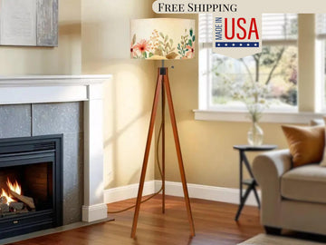 a cozy living room with a fireplace, a wooden tripod lamp shade, and a comfortable couch.