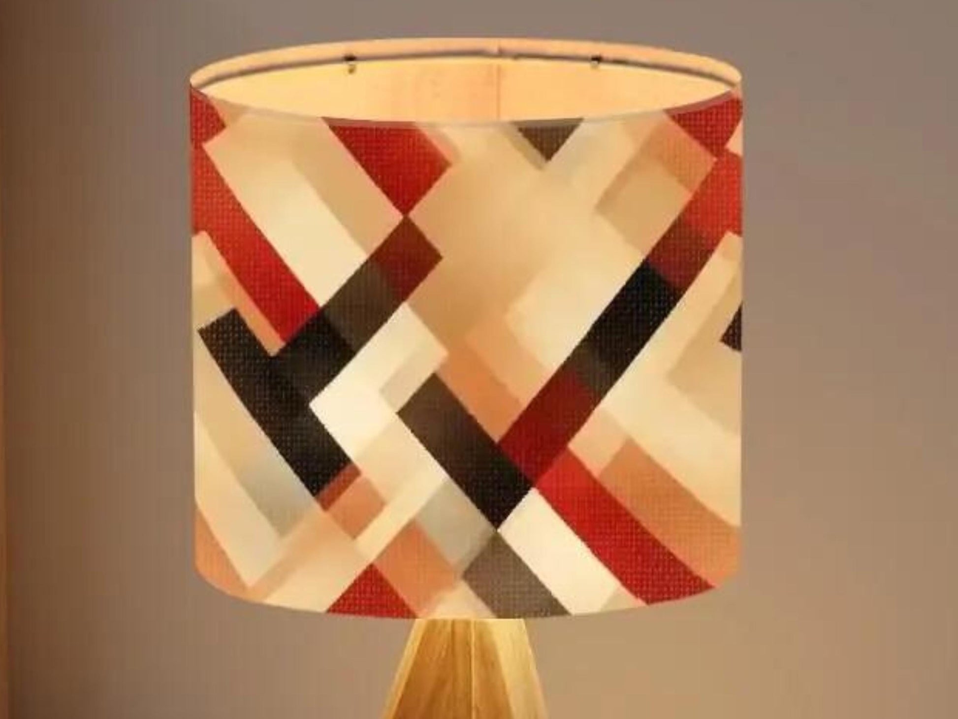 a lamp shade with a geometric pattern in red, black, and white colors.