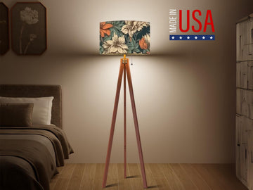 a bedroom with a bed, a lamp on a tripod, and a sign that reads "Made in USA".