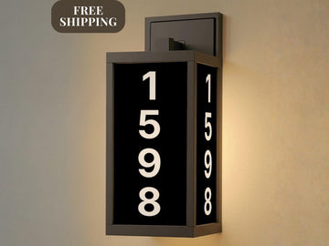 A black and white sign with the numbers "1598" displayed on it, mounted on a wall.